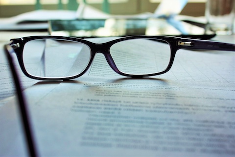 lunettes de vue posées sur des feuilles de papier